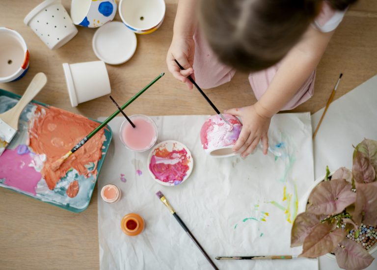 Kid painting plant pot DIY hobby